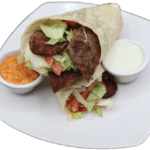 A delicious wrap containing meat and vegetables ready to be enjoyed.